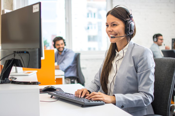 Beautiful customer service agent in headset working in call center