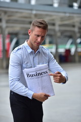 Handsome young men with business newspapers