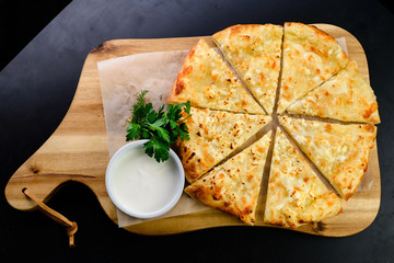 flat bread with cheese on a wooden board