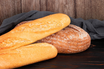 baked bread and baguette on wooden table background