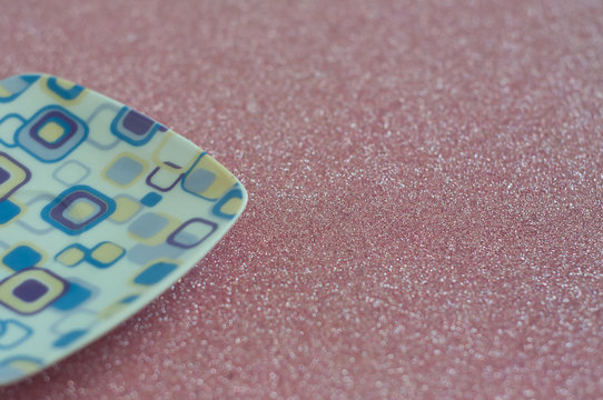 Retro vintage plate in purple and square shpaes on a glitter background.