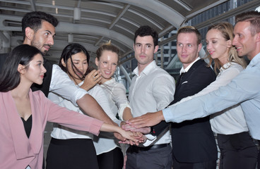 A group of young business people reading news from business newspapers