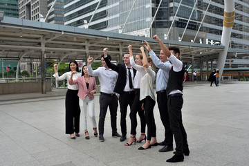 A group of young business people reading news from business newspapers