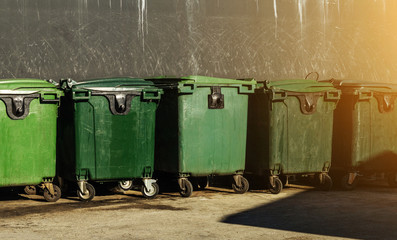 Large green plastic trash cans (garbage bin) with wheels. garbage bins to help separate and recycle