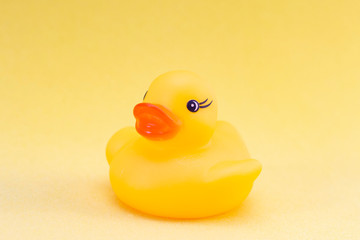 Rubber duck on a yellow background minimally creative concept. bathing babies