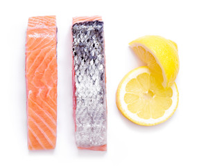 Raw salmon fillets, isolated on white background. Fresh fish, sushi quality salmon. Top view or high angle shot.
