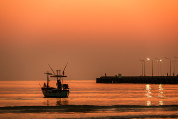 orange sunset on the sea with boats