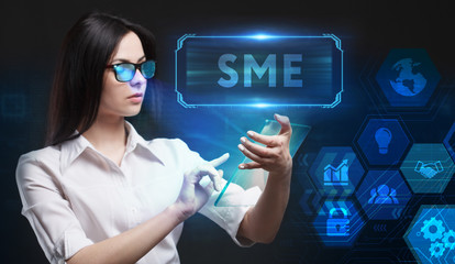 Business, Technology, Internet and network concept. Young businessman working on a virtual screen of the future and sees the inscription: SME
