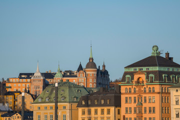 Fototapeta na wymiar Houses of the old town district Gamla Stan an Södermalm in Stockholm a sunny spring morning.