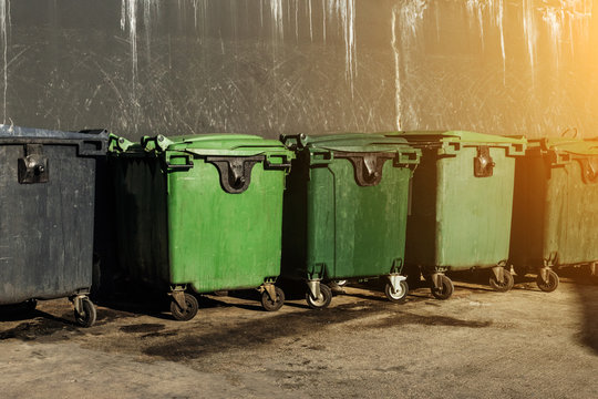 Row of green and clean rubbish bins on the street for the disposal of waste from the Coronavirus epidemic