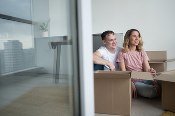 home, people, moving and real estate concept - happy couple having fun at new home.