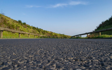 asphalt road between two hills