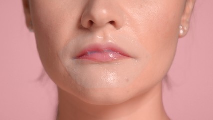 Brunette woman closeup portrait wears a lip patch treatment