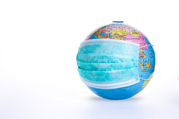 World pandemic concept. Medical mask on globe isolated on white background. Earth viral protection metaphor.