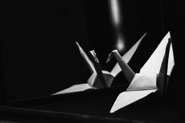 origami crane on black background