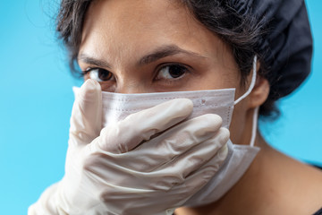 Sick girl in a medical mask on a blue background