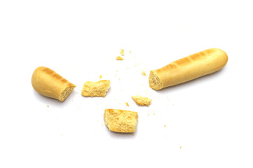 Rustic grissini bread sticks and broken with crumbs. Crispy straw biscuit isolated on white...
