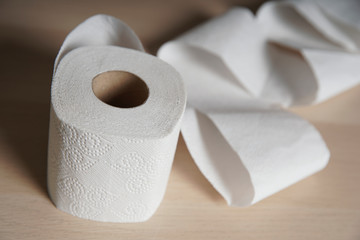 Soft hygienic toilet paper on wood background