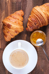 Cap coffee cappuccino and two croissant with jam