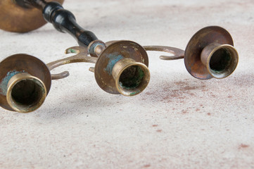 Vintage brass wood candlestick on concrete background.