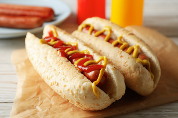 Tasty hot dogs on white wooden rustic background