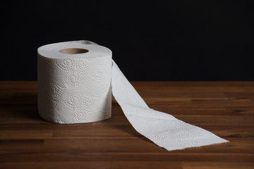 Soft hygienic toilet paper on wood background