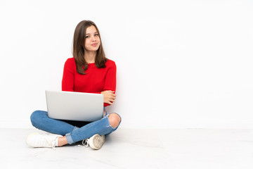 Tenaager girl working with pc isolated on white background with arms crossed and looking forward