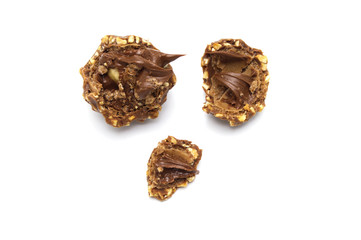 Inside of Chocolate ball sweets filling with nuts and luxury delicious isolated on white background.