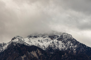 misty mountain moody landscape scenic view winter lonely peak with slightly snow cover and gray cloudy sky