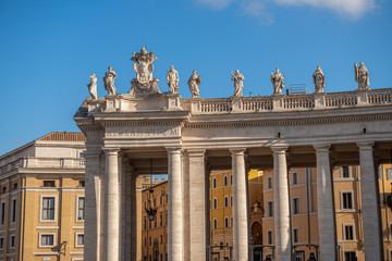Zabytkowa kolumnada wraz z rzeźbami świętych i aniołów na placu św. Piotra w Watykanie - obrazy, fototapety, plakaty