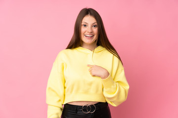 Teenager caucasian girl isolated on pink background with surprise facial expression