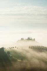 Tuscany. Villa Belvedere at early foggy morning in Val d'Orcia, Italy