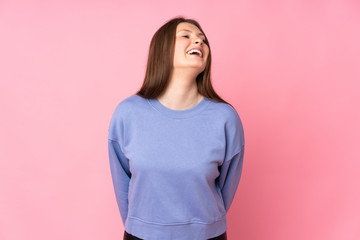 Fototapeta premium Teenager caucasian girl isolated on pink background laughing