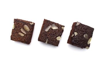 Chocolate brownie with sliced almond nuts toppings isolated on white background.