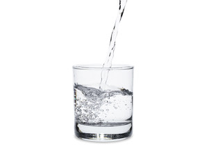 Pour water in glass isolated on white background with clipping path.