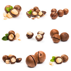 Macadamia nut with pieces and green leaves isolated on a white background