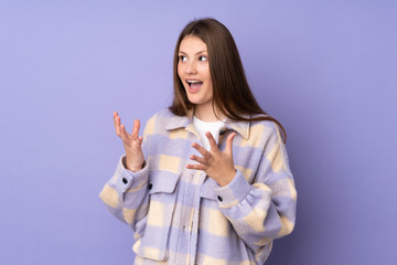 Teenager caucasian girl isolated on purple background with surprise facial expression