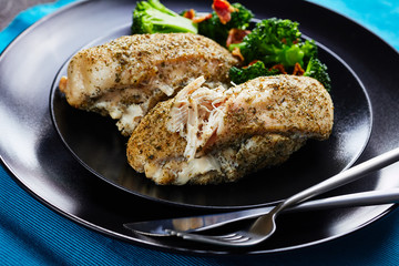 Restaurant serving of baked chicken with broccoli