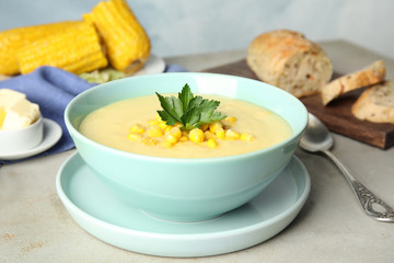 Delicious corn cream soup served on light grey table
