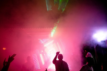 Soft focus, smoke at a night disco, vibrant stage, neon lights and beams of light at the Club Phaselis Rose Hotel in Kemer, director and animators of Turkey, a festive evening in Tekirova.