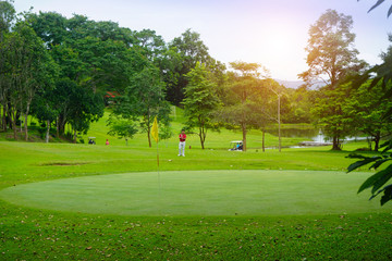 Fototapeta premium The evening golf course has sunlight shining down at golf course in Thailand