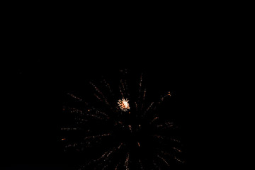 Obraz premium Salutes against the black sky, bright flashes, comets and shooting stars in the dark.