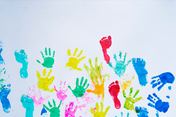 Colorful handprint and footprint of child on white background with copy space. Imprint of children during fun, painting and play. Color of childhood.