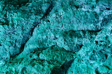Neon green textured background and wallpaper, natural surface of rock formation