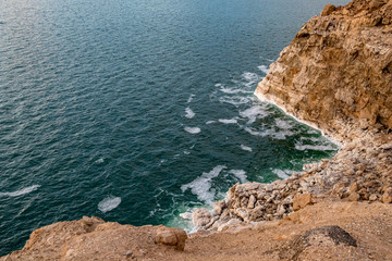 Dead sea salty shore and big salt formations. High angle view, wild nature. Tropical landscape in the winter. Afternoon, Kingdom of Jordan