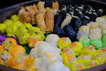 Assorted Chinese dumplings of different colors for a large company. 