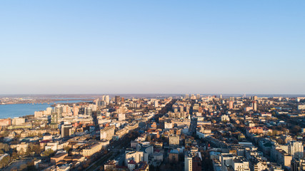 Fototapeta na wymiar Aerial urban sunny city view from drone in spring time.Top view of Dnepr city with view of river Dnipro and different buildings blocks from the high.