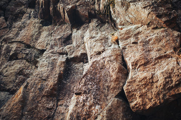 solid rock of large cobblestones of brown color close-up