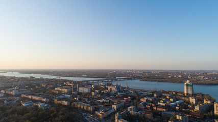 Aerial urban sunny city view from drone in spring time.Top view of Dnepr city with view of river Dnipro and different buildings blocks from the high.