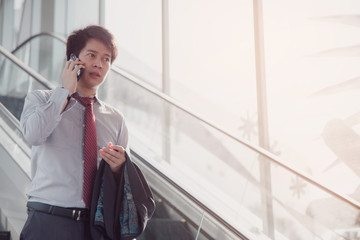 Handsome smiling confident businessman talking something on smart phone.